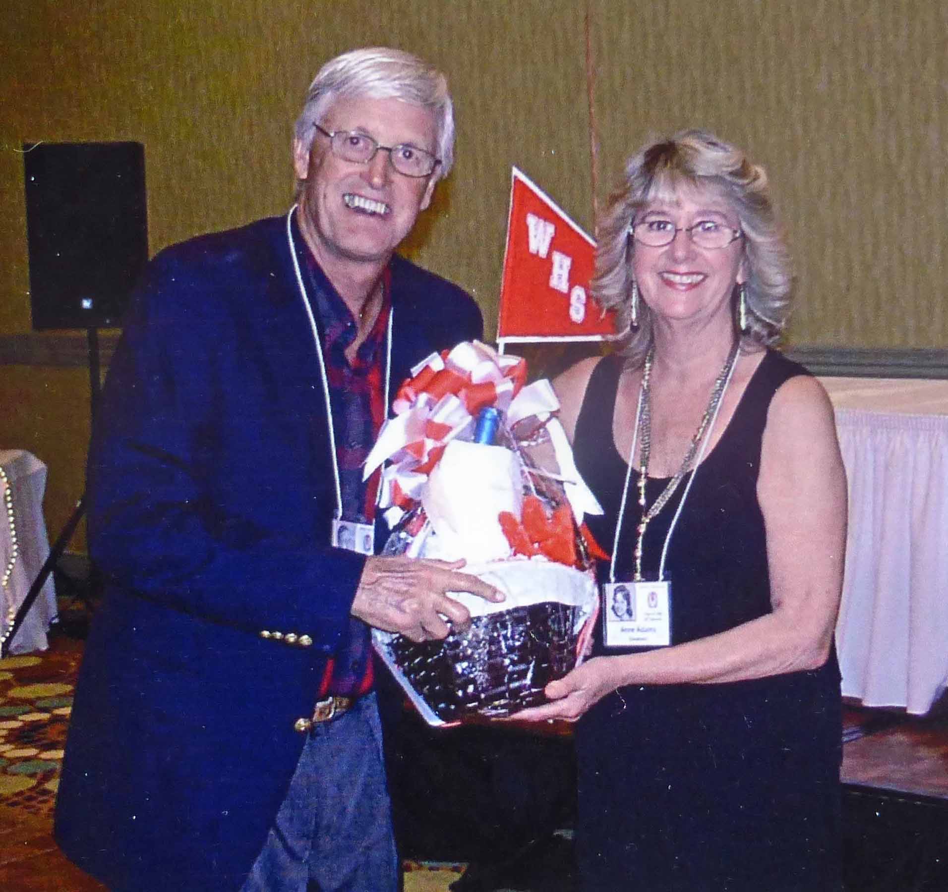 Anne Adams Goodwin presenting a raffle prize to Bill Heck.