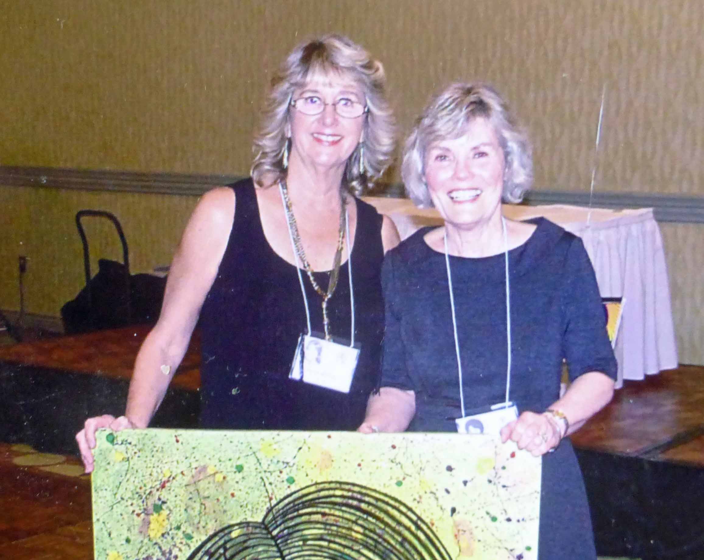 Kathy Trorey Long won a raffle prize (picture painted by Barry Bullard) presented by Anne Adams Goodwin.