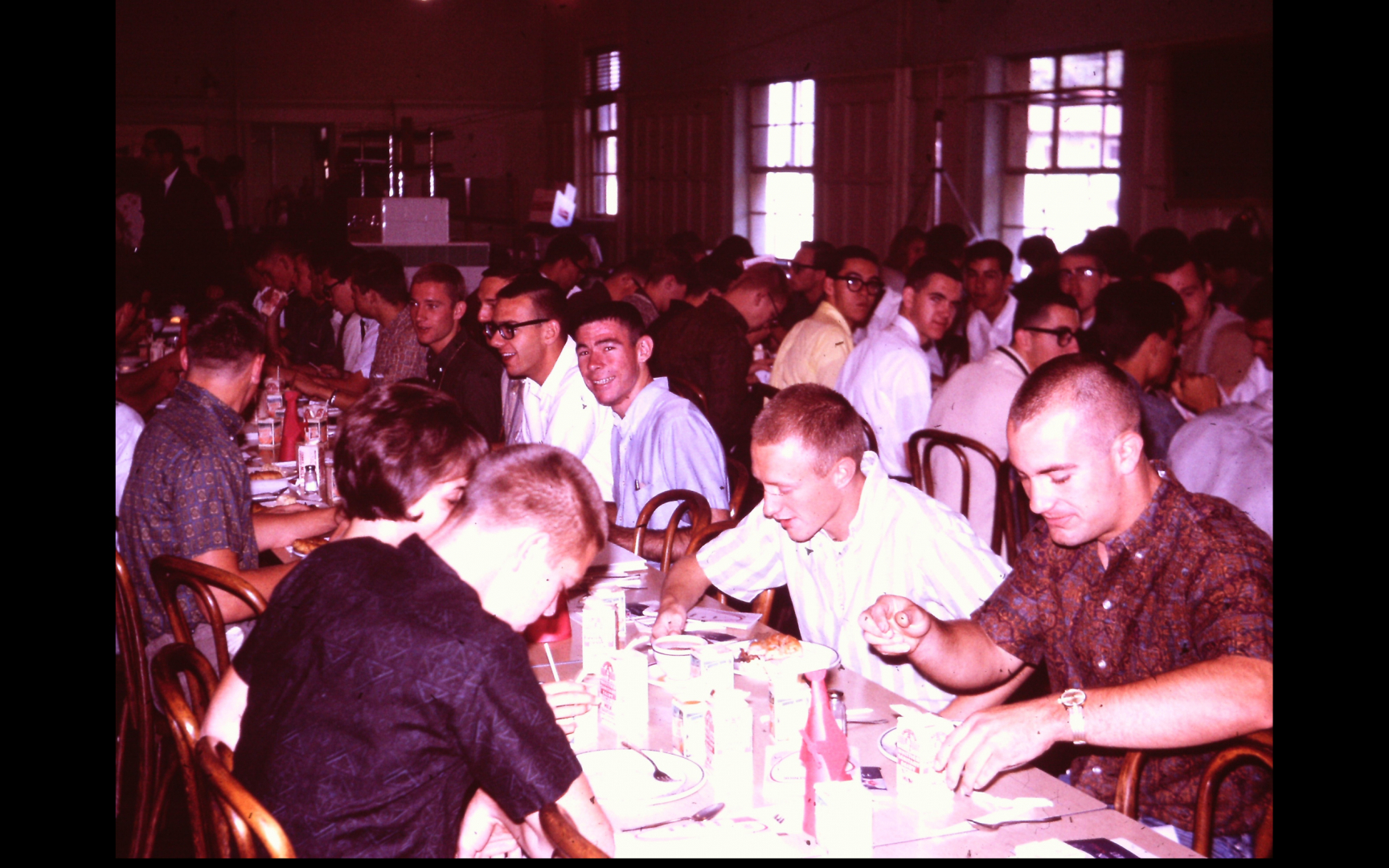 Ted (Fred) Wile is in the white shirt and dark framed glasses center left of the picture, Buddy Hamilton (me) is to his left, I think John Maus is across from me, to the right of John is a female and then I think it is Rich Rogers and across from Rich is 